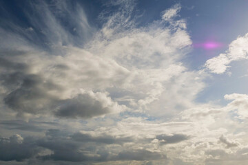 The sky is blue with a few clouds scattered throughout. The clouds are white and fluffy, giving the sky a peaceful and serene appearance