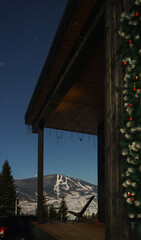 Wooden chair on house patio with snowy mountain view with copy space