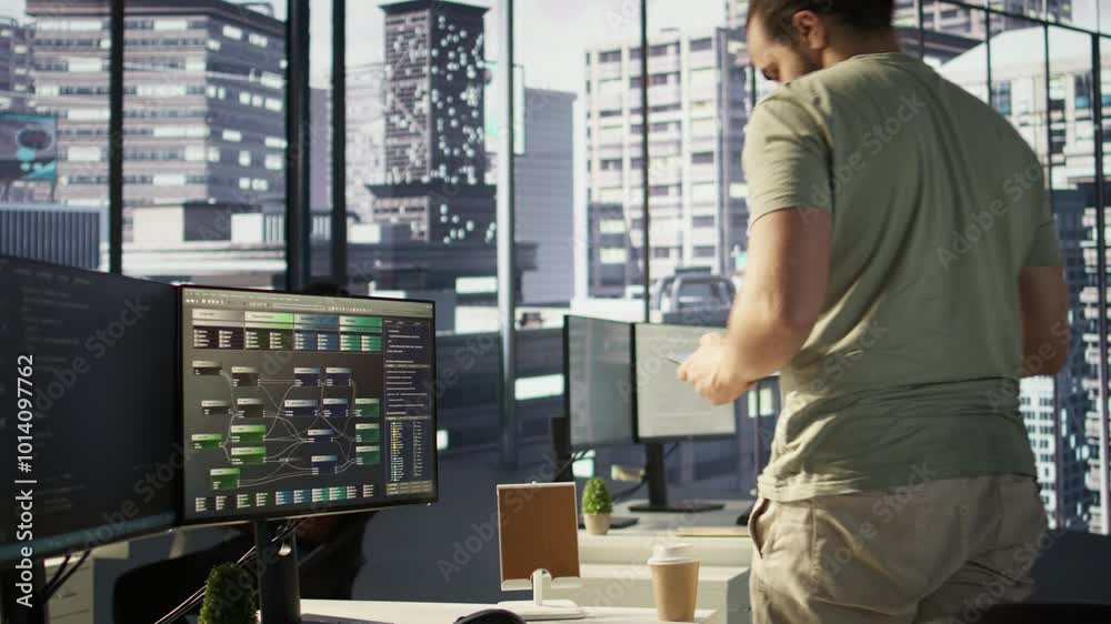 Poster system administrator checking results on tablet after creating complex machine learning models that 