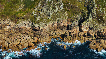 Aerial View of Rugged Coastline with Crashing Waves in Cornwall, UK