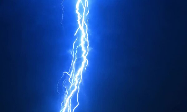 Neon blue lightning streaking across a black sky. Video