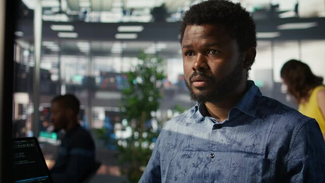Man doing data entry, typing on keyboard on PC, solving tasks. Close up of office clerk in workspace making sure documents are compliant with quality assurance expectations and standards, camera B