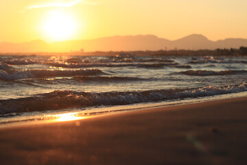 Sunset at sea. Balearic Sea, Salou, Spain. Beach, sea, small waves. Evening landscape on the coast....