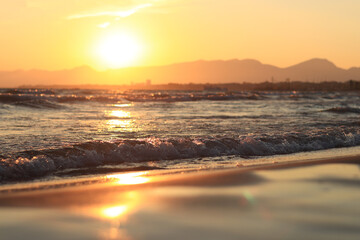 Sunset at sea. Balearic Sea, Salou, Spain. Beach, sea, small waves. Evening landscape on the coast. Vacation at sea