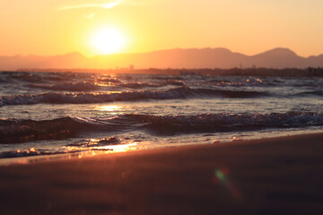 Sunset at sea. Balearic Sea, Salou, Spain. Beach, sea, small waves. Evening landscape on the coast....
