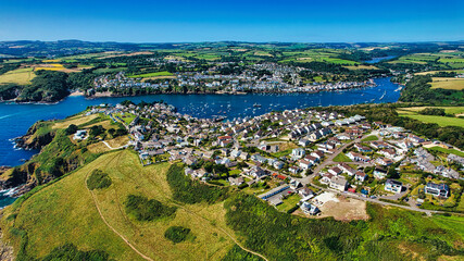 Aerial View of a Coastal Town with Harbor and Green Hills in Cornwall, UK