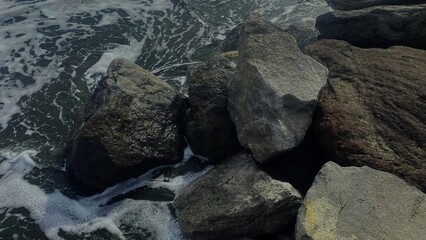 A powerful image of ocean waves crashing against rocky shores, showcasing the raw beauty of nature.
