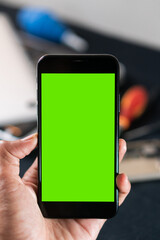 Smart phone with Green Screen in Hand