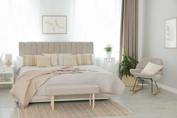 Big comfortable bed in room. Interior design