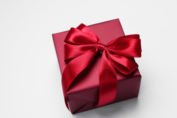 Gift box with bow on light grey background