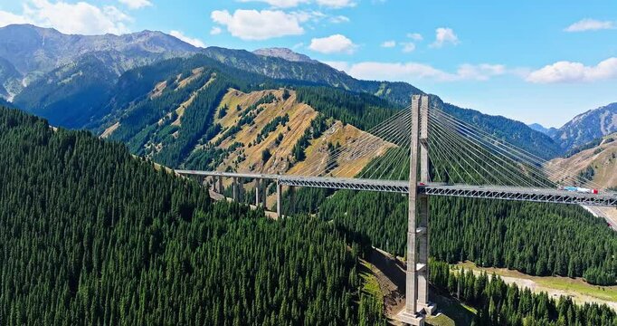 Cable stayed bridge across valley. majestic Guozigou Bridge and mountain range scenery in Xinjiang, China.