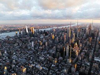 An aerial photo of Manhattan's downtown, Hudson River, and New Jersey from above during the sunrise...