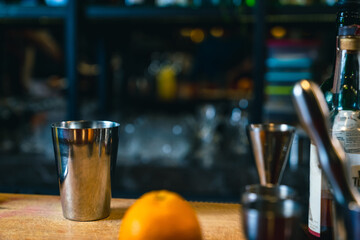 Professional male bartender preparing and serving cocktail drink to customer on bar counter at luxury nightclub. Barman making mixed alcoholic drink for celebrating holiday party at restaurant bar.