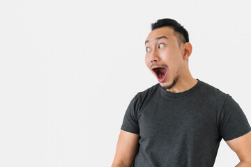 Surprised wow face Asian freelance man bun hair in black on white.