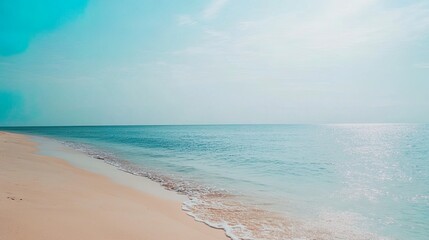 Serene beach with calm waters and soft sand.
