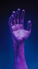 Obraz premium purple hand sculpture reaching upward on dark blue background, artistic expression concept