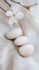 Zen stones and cherry blossoms on textured fabric