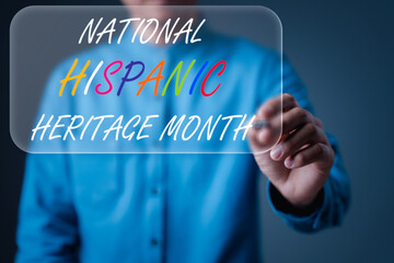 A person writes up a virtual sign with the words 'National Hispanic Heritage Month' in colorful and bold letters, highlighting cultural celebration and recognition of Hispanic heritage