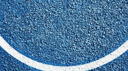 A sport field with a light blue rubberized surface, featuring crisp white lines, seen from a top view perspective.