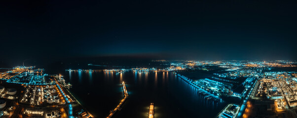 Aerial Industrial city view of white oil tank storage chemical petroleum petrochemical refinery product at oil terminal. Oil terminal storage tank in deep seaport for the international order concept.