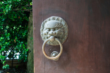 ancient wooden gate with door knocker rings close-up