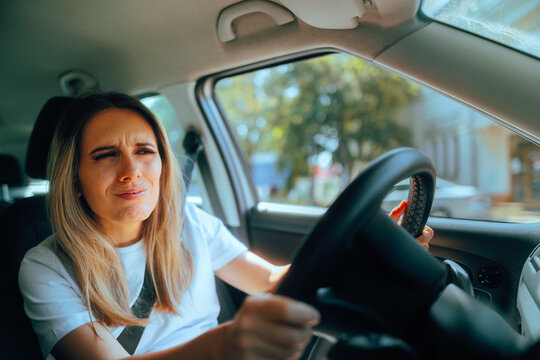 Woman Squinting Trying Drive as a Beginner Driver. Bad driver trying to focus while parking her car
