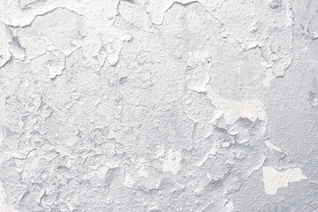 Close-up of weathered wall with peeling paint showcasing rough white grunge texture.
