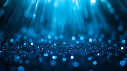Fototapeta premium Abstract bokeh of light blue illuminations holidays background, Blue glitter scattered across a surface creating a beautiful abstract bokeh backdrop.