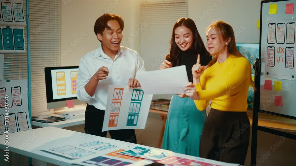 Poster group of asian ui ux designers enjoying a successful prototype presentation, expressing joy and exci