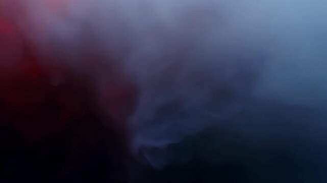 A mysterious blend of blue and red smoke swirls together in an abstract ethereal display. The haze creates a dreamy atmospheric texture perfect for background or mood enhancement.