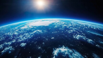 Fototapeta premium An aerial shot showcasing the curvature of planet Earth, with a blue sky and clouds in the background..