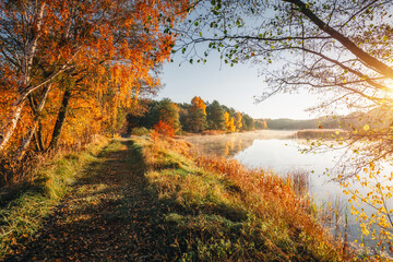An incredible dawn on an autumn lake with warm sunlight. Small Polissya, Ukraine, Europe.