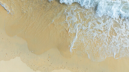 Top view beach sand background for summer vacation concept. Beach nature and summer seawater with sunlight light sandy beach Sparkling sea water	
