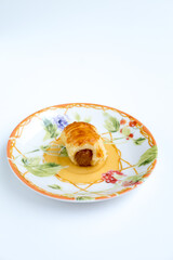 Pineapple tart cookies also known as Nastar served in a ceramic plate, isolated on white background.