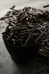 Pile of wood in basket preparing for firewood in vertical