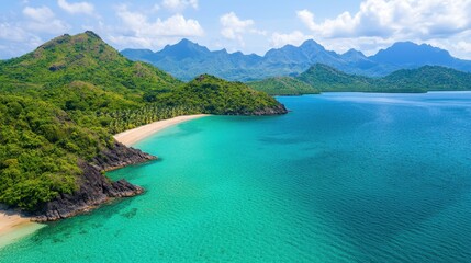 Aerial view of a pristine tropical beach surrounded by lush green mountains and clear blue water.