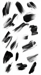 A collection of black brushstrokes in various sizes, from thin delicate lines to broad sweeping strokes, randomly placed on a white background, creating an abstract pattern.