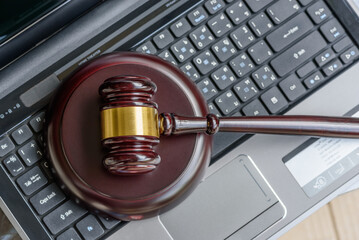 Consumer protection law, rights and online guarantees, justice concept : Judge gavel on a laptop,...
