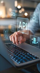 Obraz premium API: a businessman using a laptop with a hologram of API, virtual interface that hologram of API,API integration, API development, JSON, API documentation, Application prgramming interface