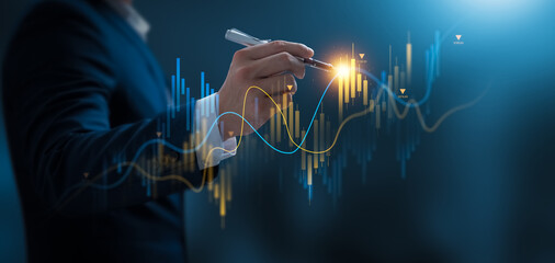 Businessman using pen touch candle chart financial growth of business and world economy. Stock...