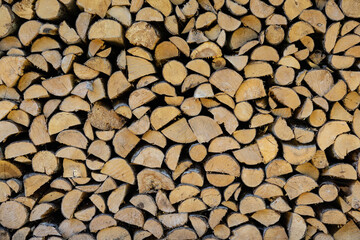 stacked pile of cut fry firewood for winter