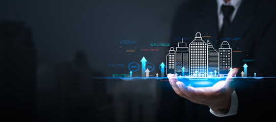 Businessman holding virtual graph showing real estate market growth. Perfect for financial, real...