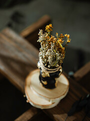 Black candle with herbs, wormwood, St. John's wort., tools for ritual concept photo. Dark witch...