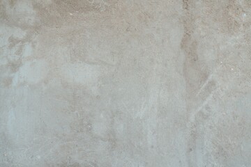 Textured Plaster Wall Background. A close-up of a textured plaster wall with an abstract rough surface. The neutral light beige color and irregular patterns create a natural and artistic backdrop. 