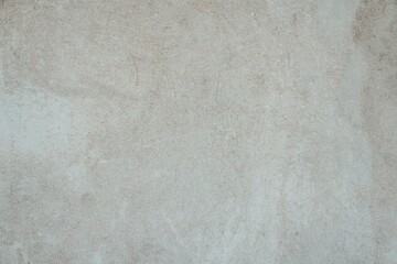 Textured Plaster Wall Background. A close-up of a textured plaster wall with an abstract rough surface. The neutral light beige color and irregular patterns create a natural and artistic backdrop. 