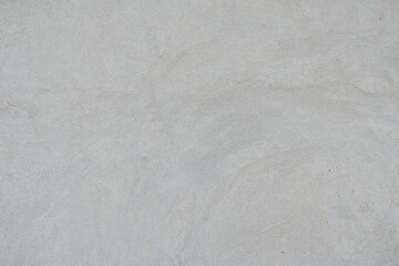Textured Plaster Wall Background. A close-up of a textured plaster wall with an abstract rough surface. The neutral light beige color and irregular patterns create a natural and artistic backdrop. 