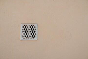 retro ventilation grille on wall, plaster background