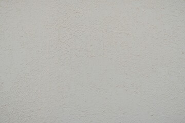 Textured Plaster Wall Background. A close-up of a textured plaster wall with an abstract rough surface. The neutral light beige color and irregular patterns create a natural and artistic backdrop. 