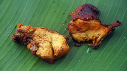 Fried chicken meat on banana leaves, focus selected