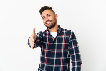 Caucasian man isolated on white background shaking hands for closing a good deal